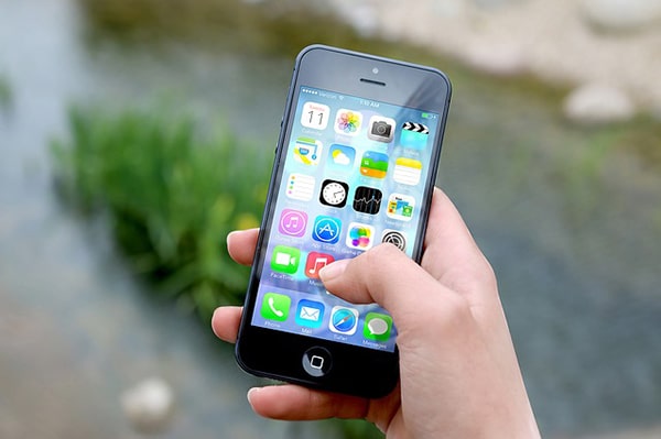 hand holding a phone with apps