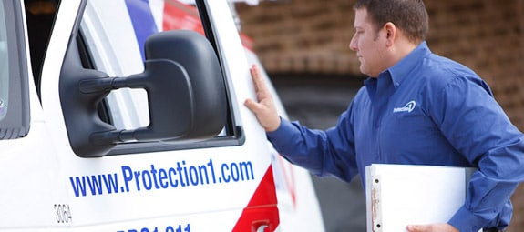 Protection One technician closing door to van