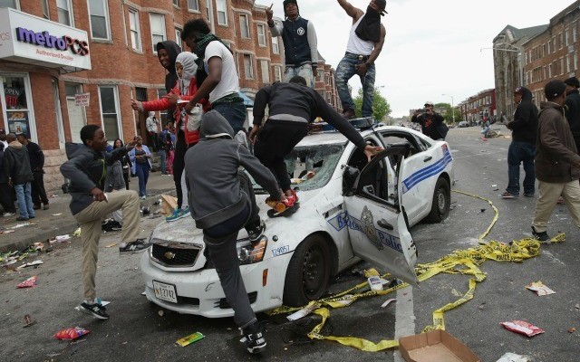 Riot jumping on police cars
