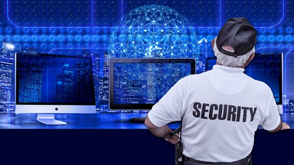 security guy facing the monitors