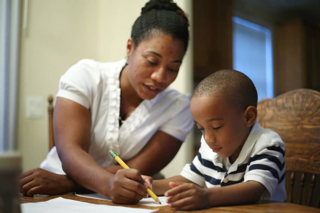 Single parent helping child do math