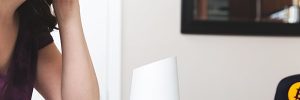 woman talking to smart device about abode home security system